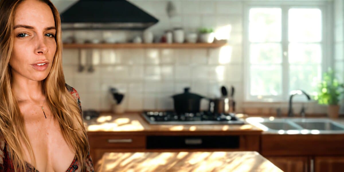 Author Ava Tyler standing in a sunlit kitchen, featured in wellness and culinary education article.