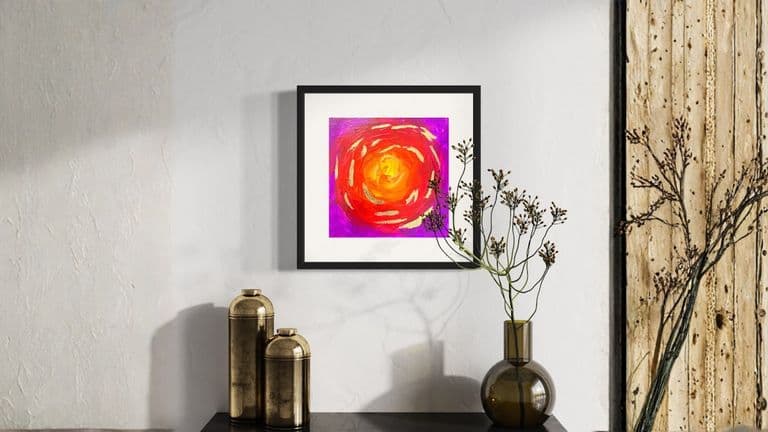 A vibrant, colorful abstract painting featuring swirling reds, oranges, and pinks, evoking energy and imagination in a minimalist setting.