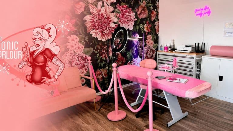 Interior of The Iconic Parlour featuring treatment bed, floral mural, and welcoming beauty studio environment.