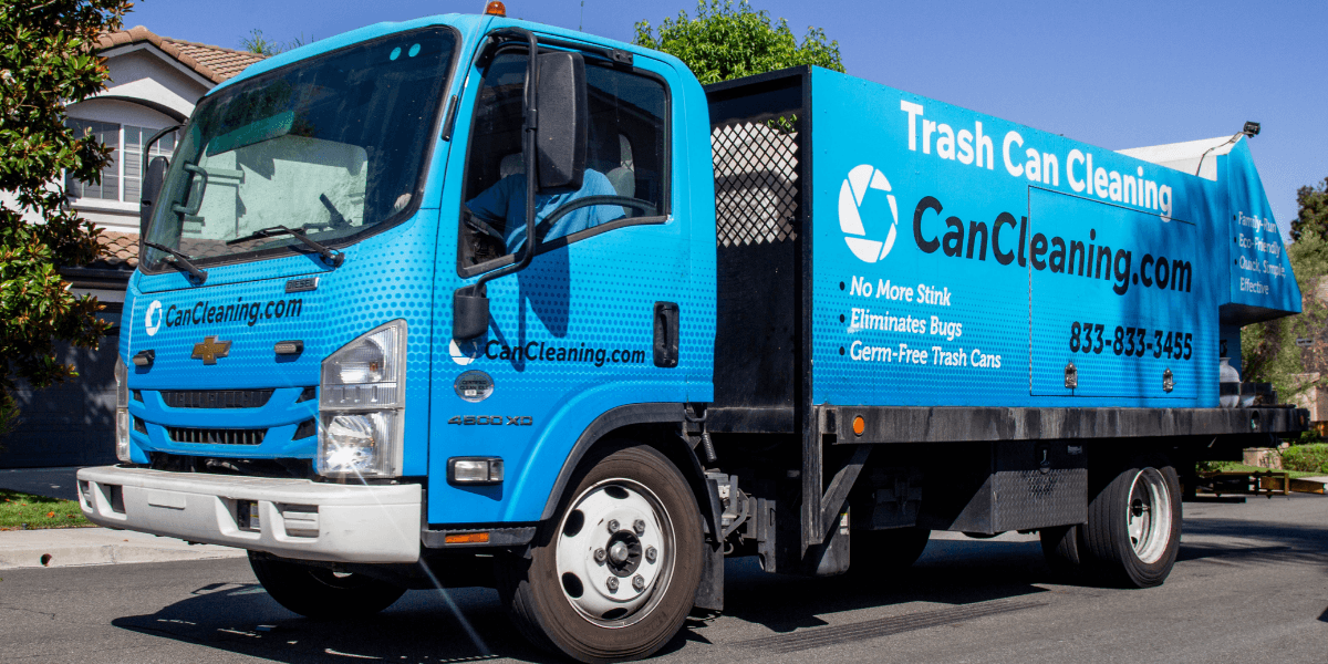 A blue trash cleaning truck parked on a residential street