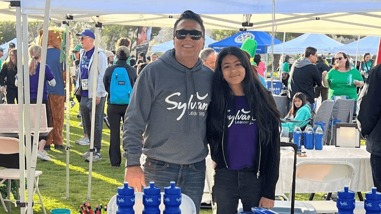 Sandeep Malik and a student at Sylvan Learning Center, promoting personalized education at a local event.