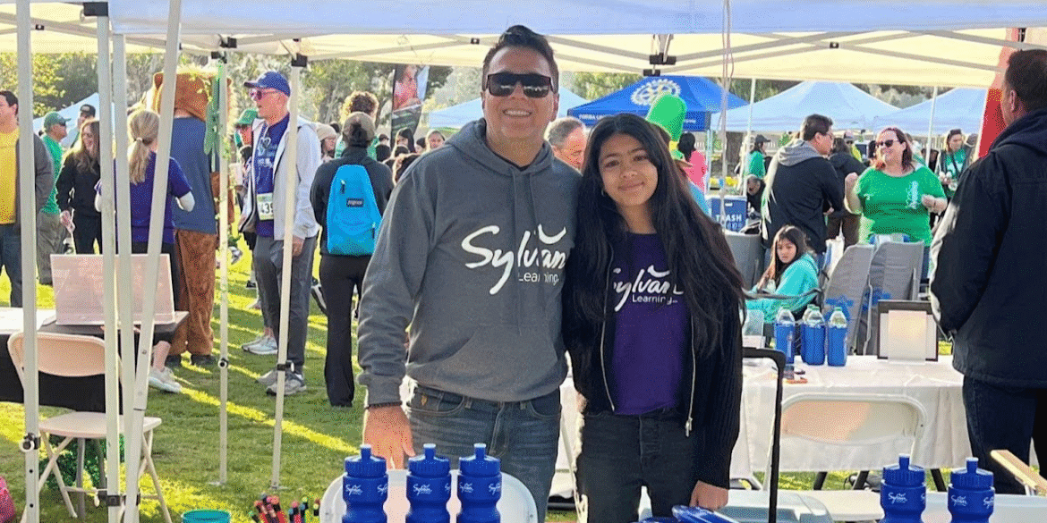 Sandeep Malik and a student at Sylvan Learning Center, promoting personalized education at a local event.