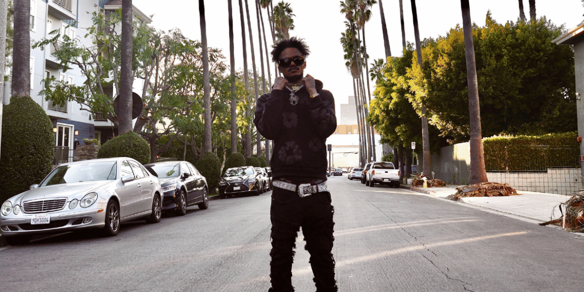 "Hip-hop artist KingfromHeaven standing on a Los Angeles street, embodying the energy and style of the city's music scene."