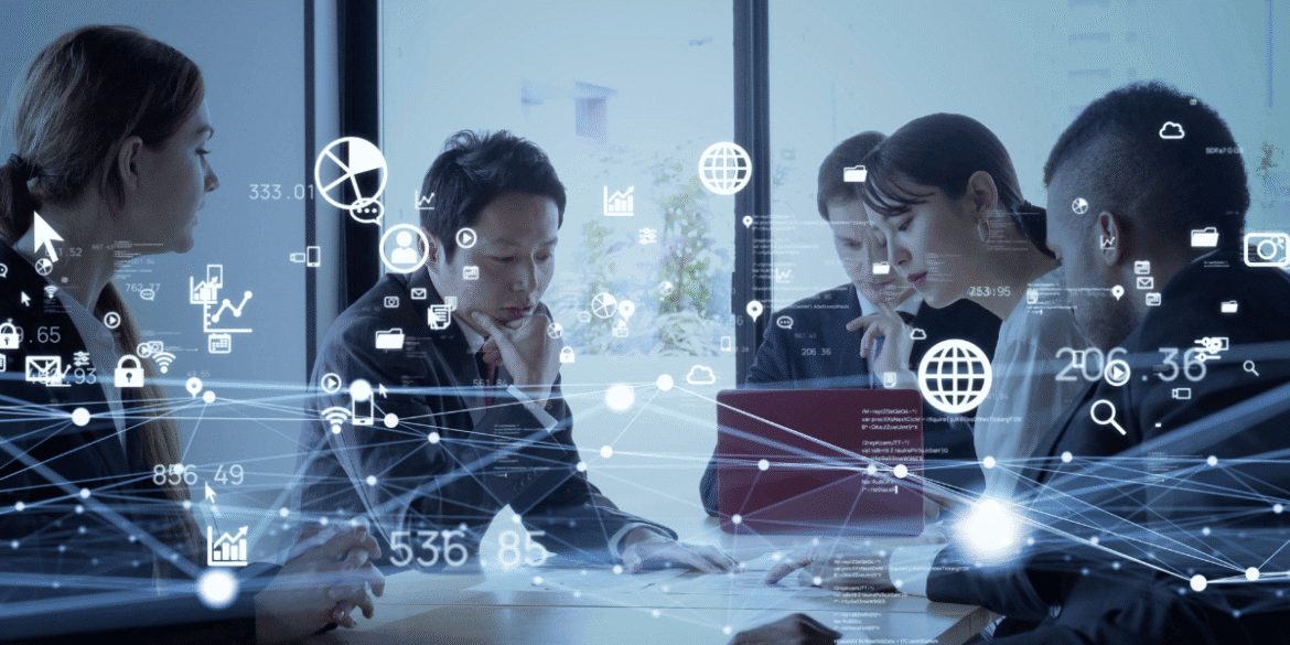 Business team collaborating around a table with digital network, data, cloud, and analytics graphics overlaid.